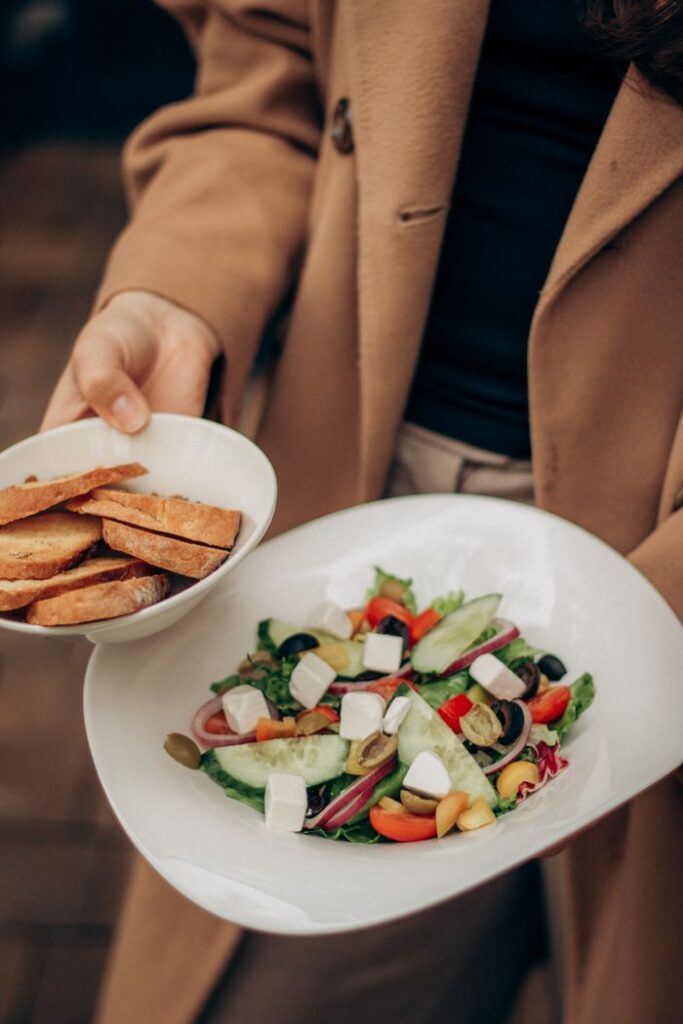 pexels-photo-34337569 Close-up of a colorful Mediterranean salad with fresh vegetables and bread slices.